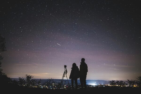 A couple stargazes under a starry sky in Elkton, VA, capturing the beautiful Milky Way.