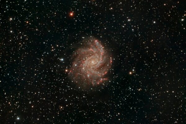Capture of a spiral galaxy surrounded by stars, showcasing the vastness of space.