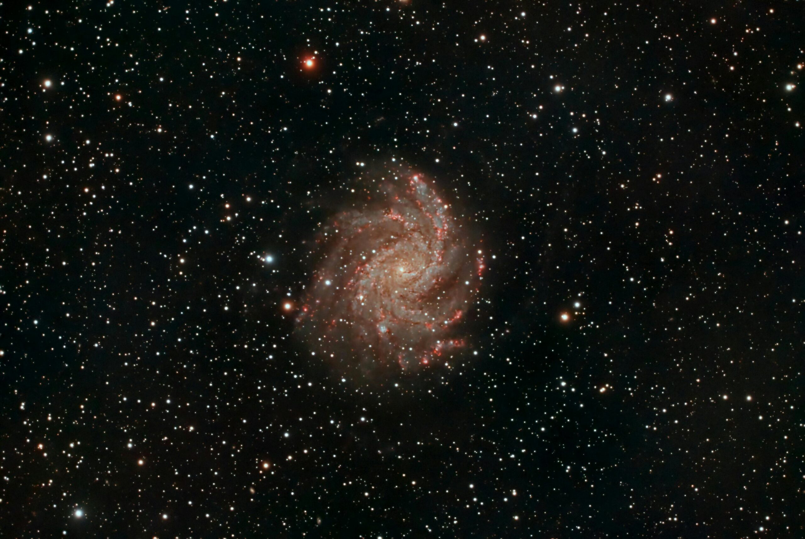 Capture of a spiral galaxy surrounded by stars, showcasing the vastness of space.