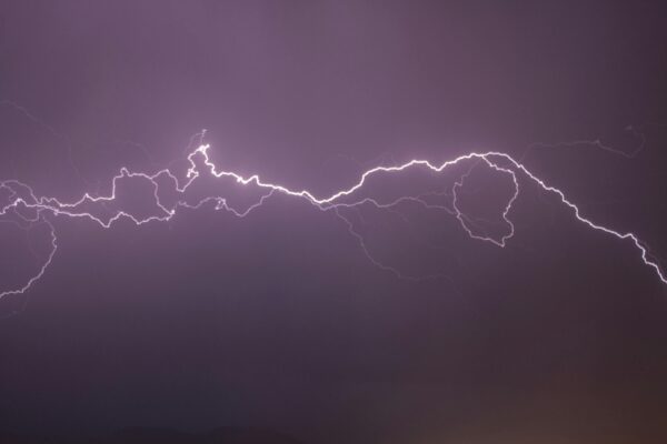 A vivid display of lightning bolts illuminating the night sky, capturing the electric power of a thunderstorm.