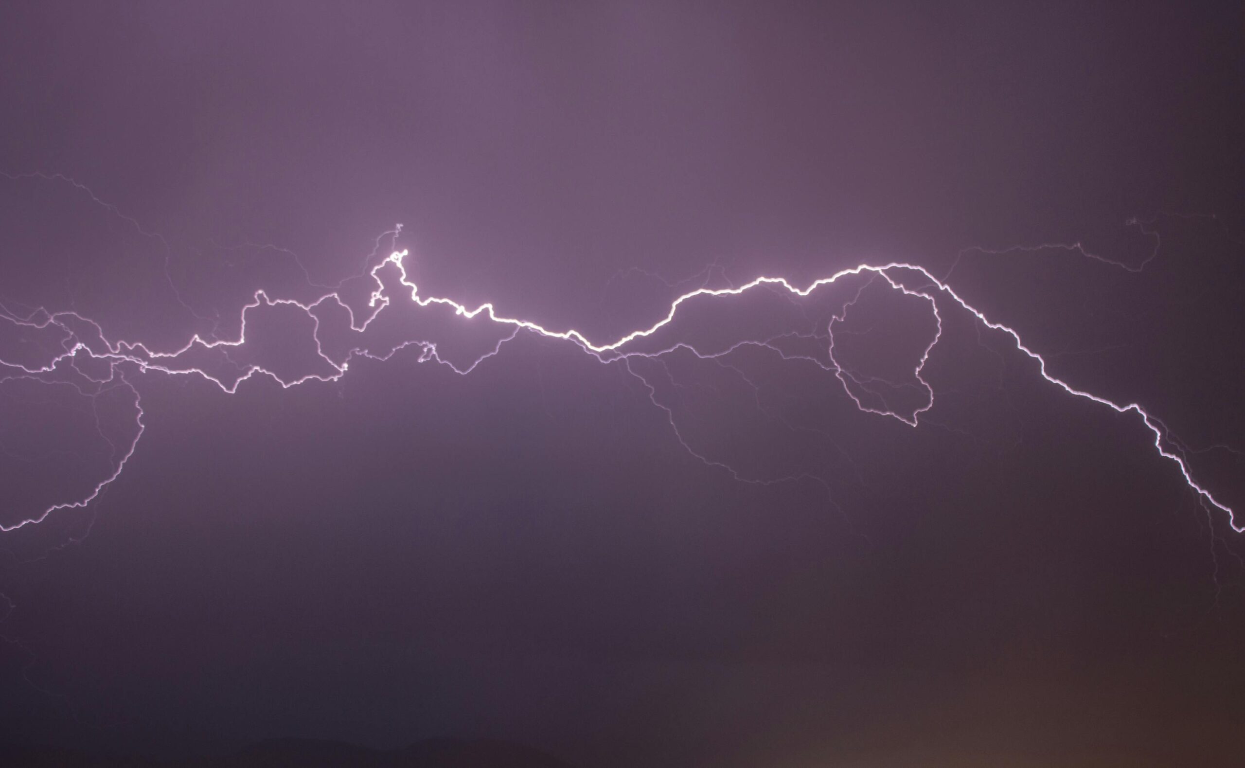 A vivid display of lightning bolts illuminating the night sky, capturing the electric power of a thunderstorm.