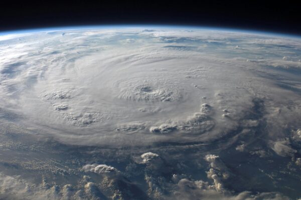 The Fastest Wind Ever Recorded on Earth: Cyclone Olivia’s Incredible Gust A stunning aerial view of Earth with a massive swirling hurricane, highlighting meteorological beauty.