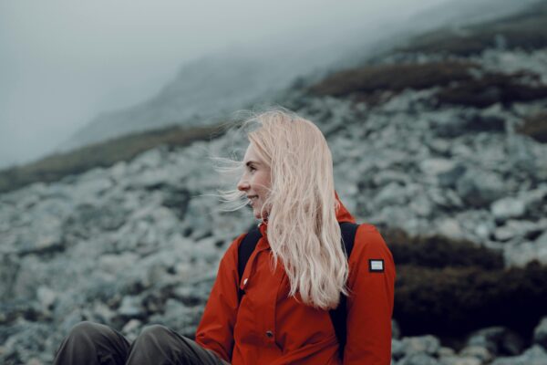 Portrait of a young woman hiking in a misty mountain setting, exuding a sense of adventure and tranquility.