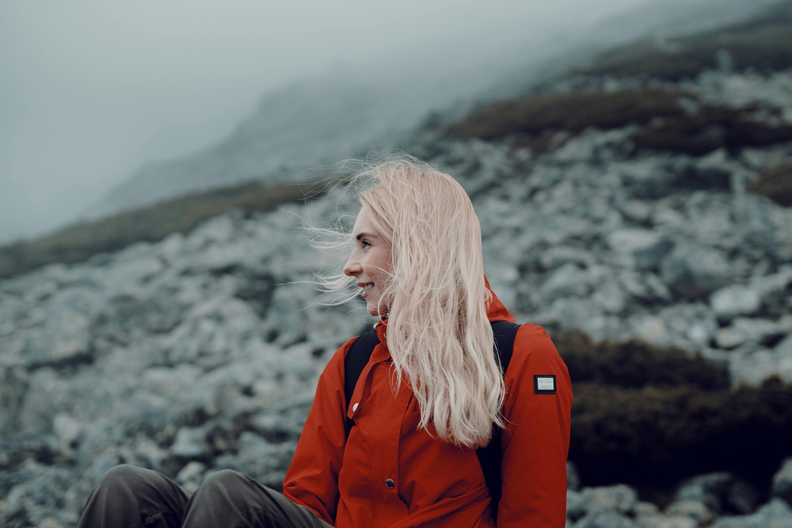 Portrait of a young woman hiking in a misty mountain setting, exuding a sense of adventure and tranquility.